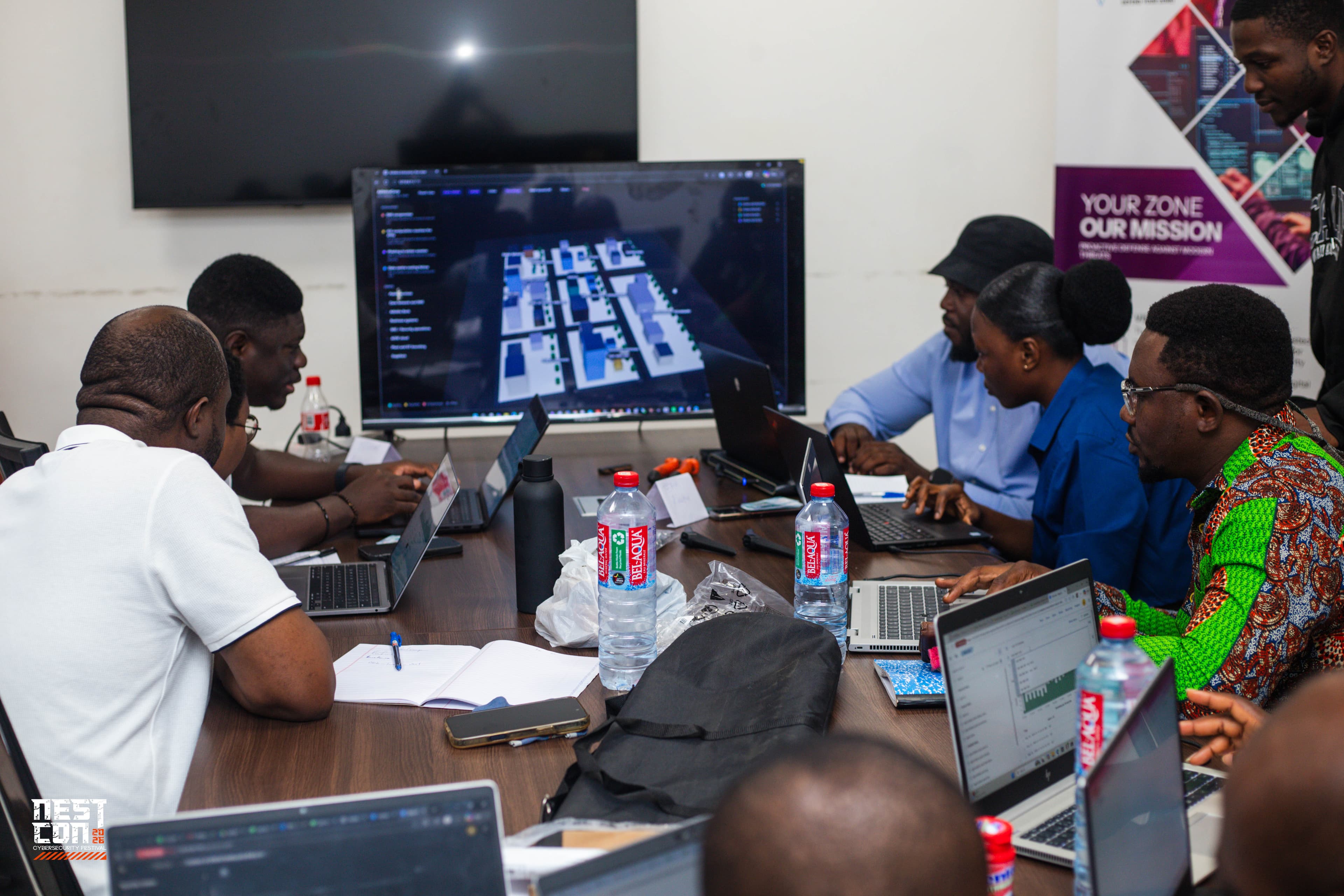 A group reviews a live network dashboard together in a briefing room.