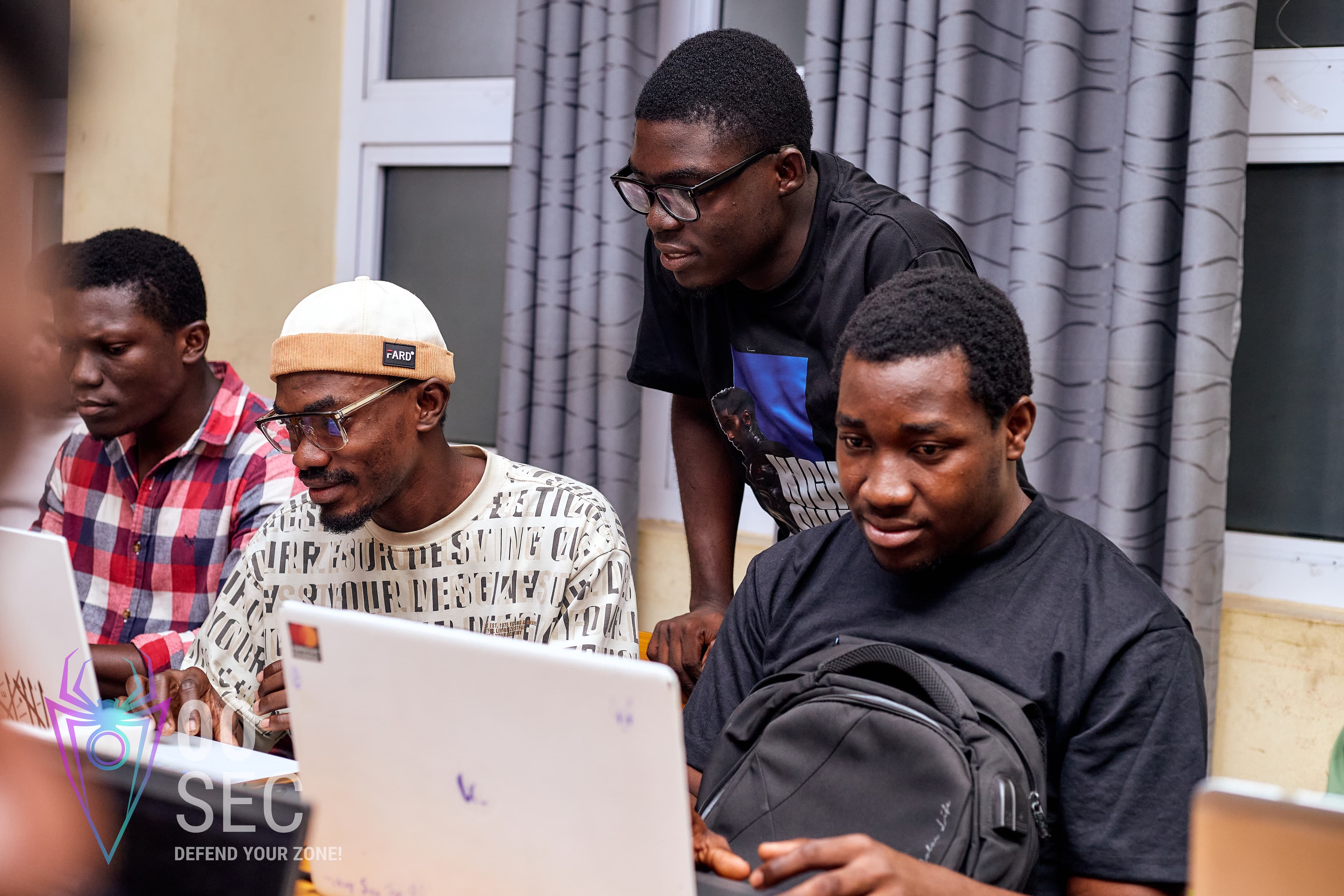 Students collaborating over a laptop during a hands-on club session.