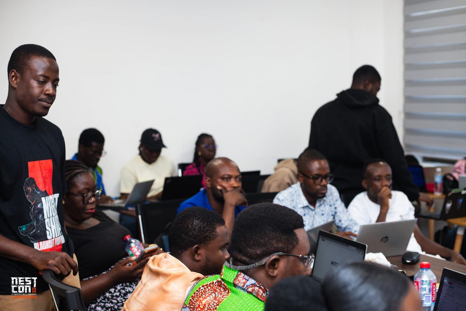 NESTCON attendees working through a hands-on session on laptops in a training room.