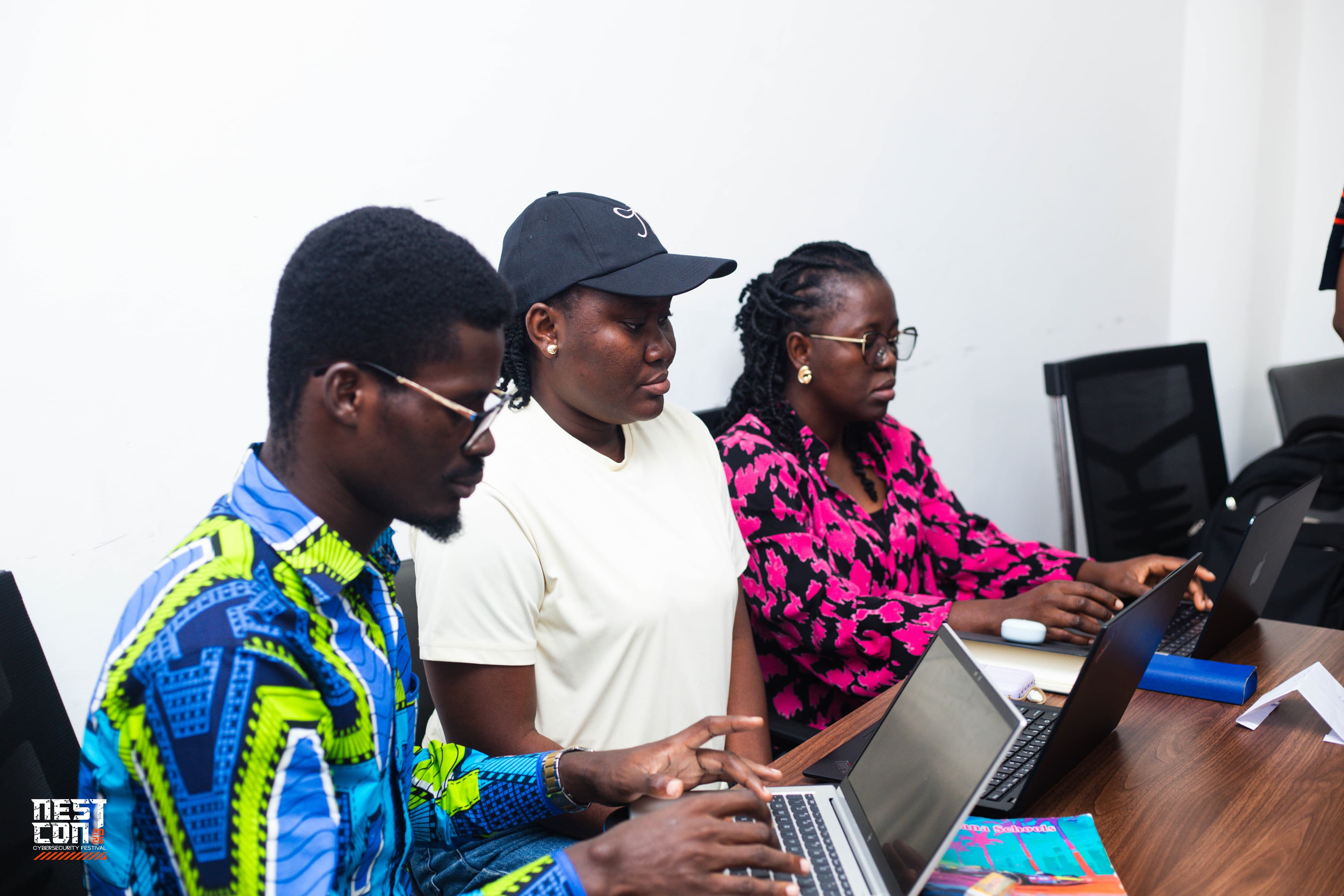 Attendees working together on laptops during a NESTCON community session.